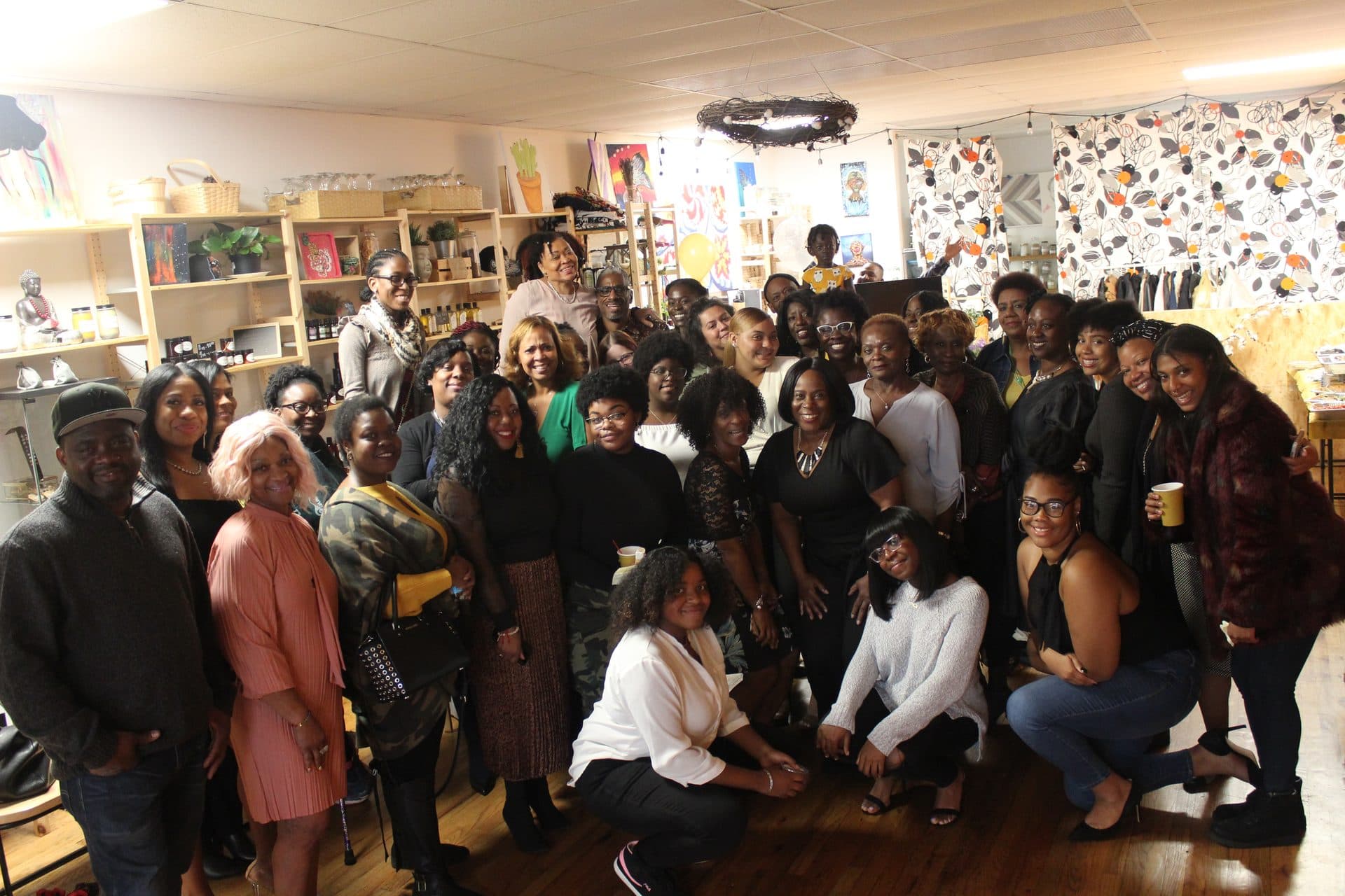 A large group of Girls Mentor Girls mentors and mentees gathered together, smiling.