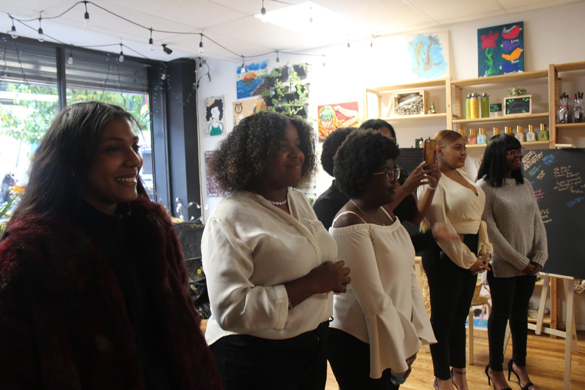 A group of GMG members gathered together inside a community space.